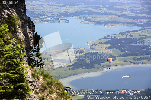 Image of  Paragliders flying over Bavarian lake Forggensee