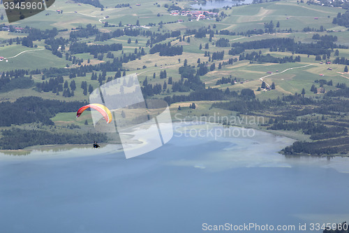 Image of Paraglider flying over Bavarian lake