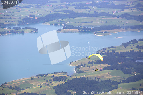 Image of Paraglider flying over Bavarian lake