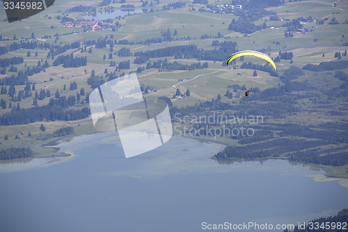 Image of  Paraglider flying over Bavarian lake