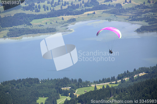 Image of Paraglider flying over Bavarian lake