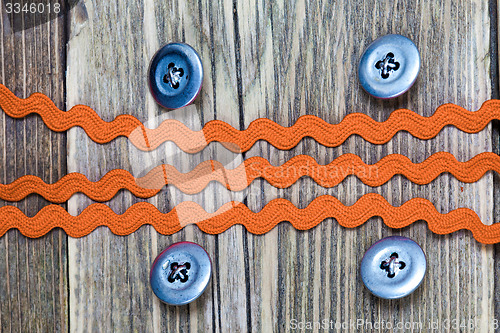 Image of vintage buttons and old red band