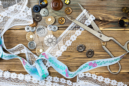 Image of vintage buttons, lace, and a dressmaker scissors