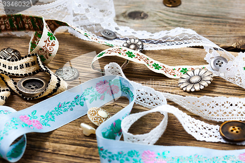 Image of ribbon, lace, tape with embroidery and buttons