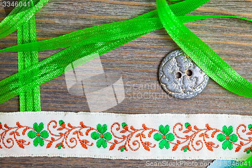 Image of vintage embroidered band and tape with old classic button