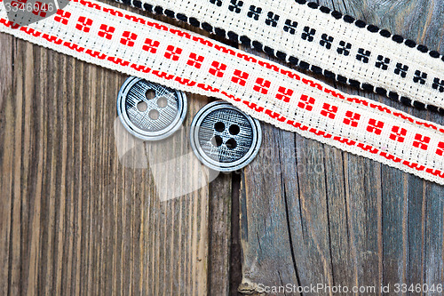 Image of vintage ribbons with embroidered ornaments and old button