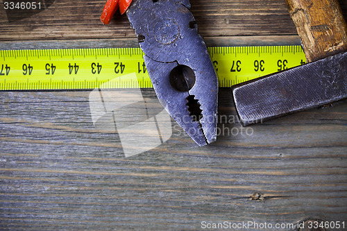 Image of vintage pliers and old hammer