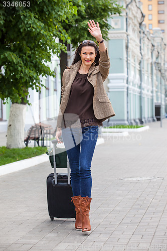 Image of pretty adult woman traveler with suitcase