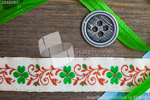 Image of vintage ribbons, tape and one classic button 