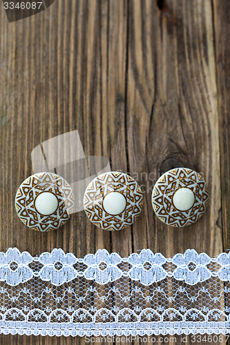 Image of three vintage button and lace tape