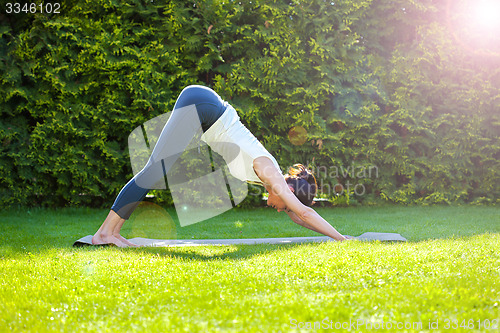Image of beautiful adult woman practicing yoga