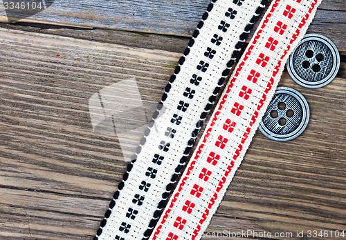 Image of old band with embroidered ornaments and vintage buttons