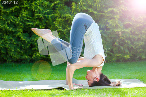 Image of beautiful adult woman doing yoga