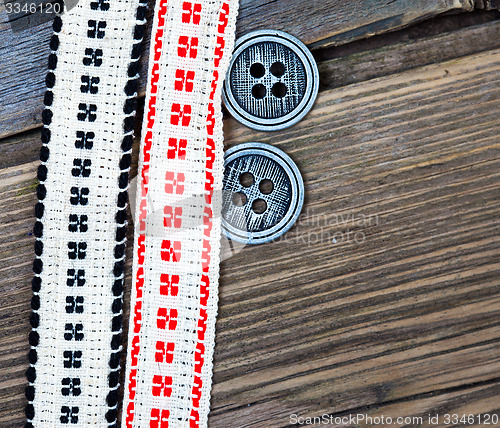 Image of two vintage tape with embroidered ornaments and old buttons