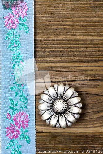 Image of vintage aqua color band with embroidered ornaments and old butto