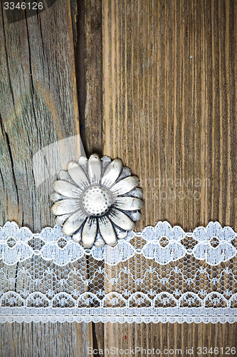 Image of vintage metal button and lace tape