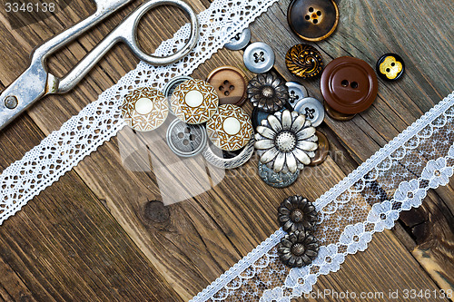 Image of vintage buttons, lace, and a dressmaker scissors