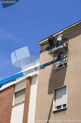 Image of Worker on lift bucket