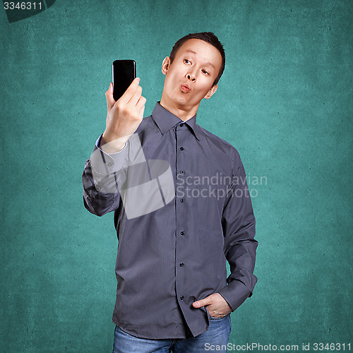 Image of Asian Man Making A Selfie