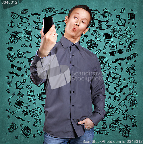Image of Asian Man Making A Selfie