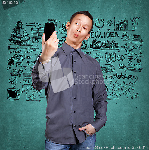 Image of Asian Man Making A Selfie