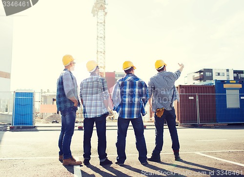 Image of group of builders in hardhats outdoors