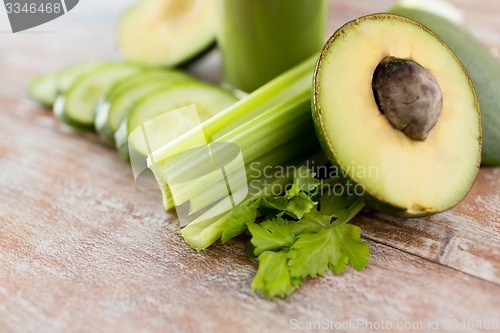 Image of close up of fresh green juice glass and vegetables