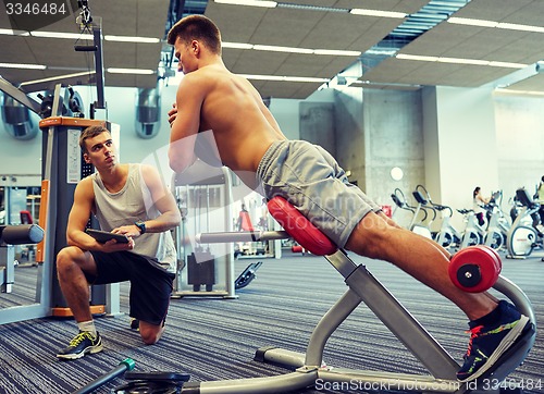 Image of men exercising on gym machine