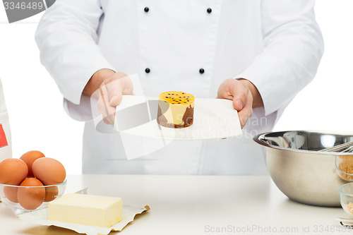 Image of close up of male chef cook baking dessert