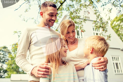 Image of happy family in front of house outdoors