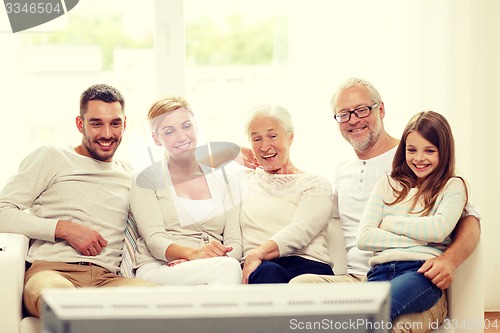 Image of happy family watching tv at home