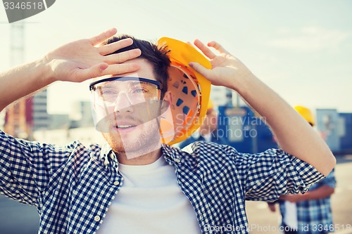 Image of group of builders in hardhats outdoors