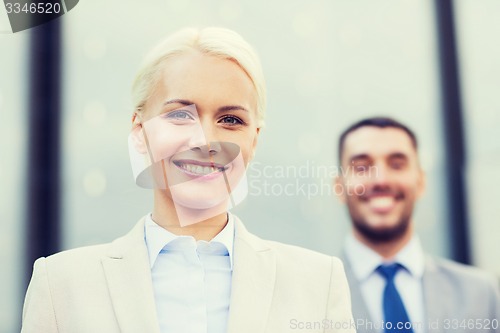 Image of smiling businessmen outdoors