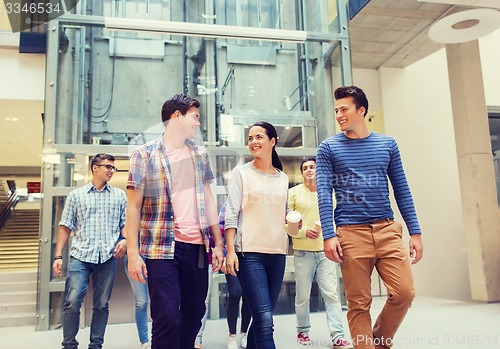 Image of group of smiling students with paper coffee cups