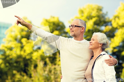 Image of senior couple hugging in park