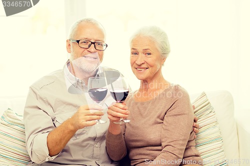 Image of happy senior couple with glasses of red wine