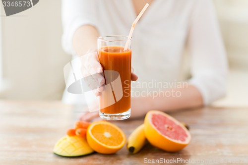 Image of close up of woman hands with juice and fruits