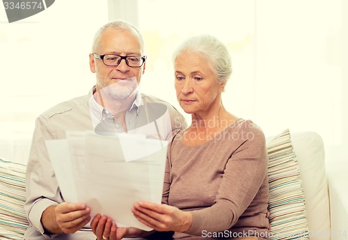 Image of senior couple with papers at home