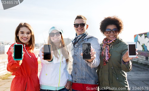 Image of smiling friends showing blank smartphone screens