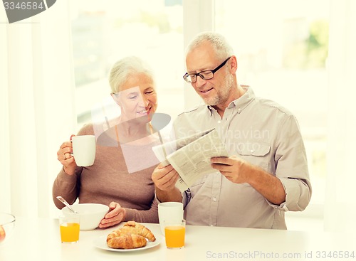 Image of happy senior couple having breakfast at home