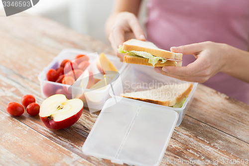 Image of close up of woman with food in plastic container