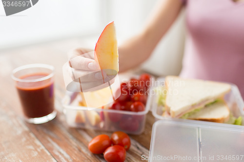 Image of close up of woman with food in plastic container