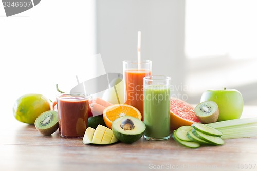 Image of close up of fresh juice glass and fruits on table