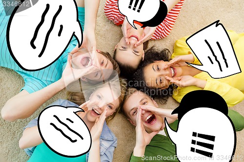 Image of smiling people lying down on floor and screaming