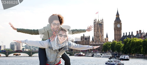 Image of happy teenage couple having fun over london city