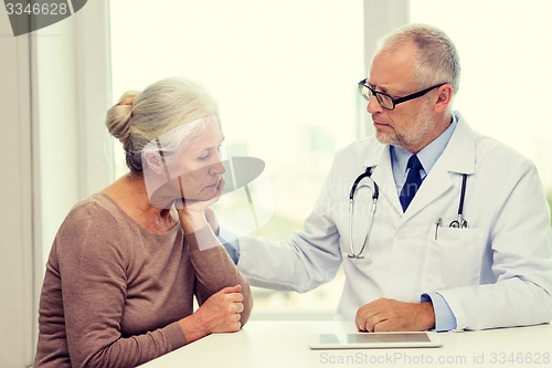 Image of senior woman and doctor with tablet pc