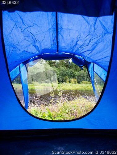 Image of view from blue tourist tent entrance to nature