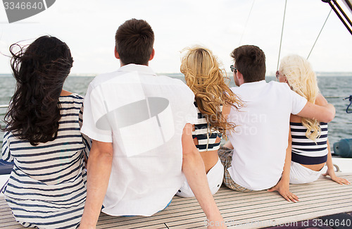 Image of group of friends sitting on yacht deck