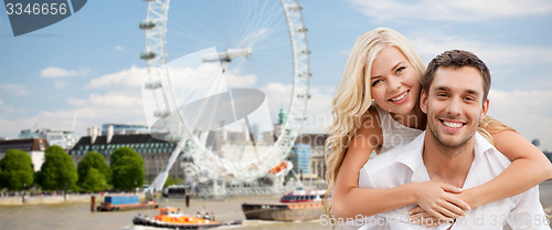 Image of happy couple hugging over london ferry wheel