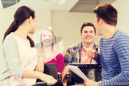 Image of group of smiling students with notebook